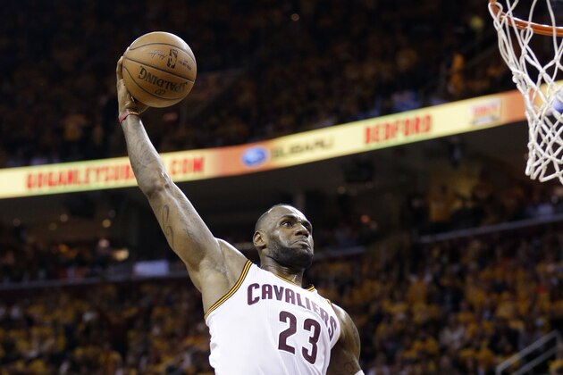 Cleveland Cavaliers' LeBron James (23) goes in for a dunk against Toronto Raptors' Kyle Lowry (7) during the second half of Game 1 of the NBA basketball Eastern Conference finals, Tuesday, May 17, 2016, in Cleveland. (AP Photo/Tony Dejak)