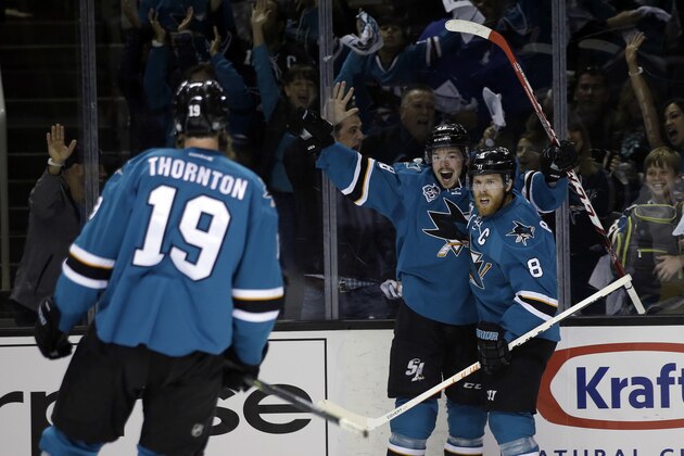 San Jose Sharks' Tomas Hertl (48) celebrates his goal with teammates Joe Pavelski (8) and Joe Thornton (19) during the first period in Game 3 of the NHL hockey Stanley Cup Western Conference finals against the St. Louis Blues on Thursday, May 19, 2016, in San Jose, Calif. (AP Photo/Marcio Jose Sanchez)