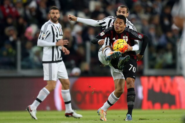 Juventus' defender Giorgio Chiellini (back) vies with AC Milan's Colombian forward Carlos Bacca during the Italian Serie A football match between Juventus and AC Milan on November 21, 2015 at the Juventus Stadium in Turin.  AFP PHOTO / MARCO BERTORELLO        (Photo credit should read MARCO BERTORELLO/AFP/Getty Images)