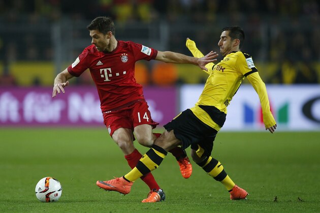 DORTMUND, GERMANY - MARCH 05:  Henrikh Mkhitaryan (R) of Borussia Dortmund challenges Xabi Alonso of Bayern Munich during the Bundesliga match between Borussia Dortmund and FC Bayern Muenchen at Signal Iduna Park on March 5, 2016 in Dortmund, Germany.bs  (Photo by Boris Streubel/Getty Images)