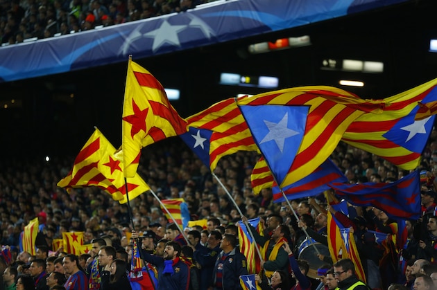 Barcelona fans wave Estelada independence flags during a Champions League quarter-final, first leg soccer match between FC Barcelona and Atletico Madrid at the Camp Nou stadium in Barcelona, Spain, Tuesday April 5, 2016. (AP Photo/Manu Fernandez)