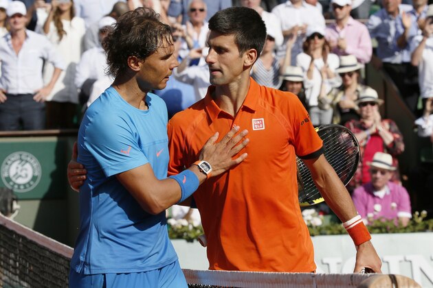 Spain's Rafael Nadal (L) shakes hands with Serbia's Novak Djokovic at the end of their men's quarter final match of the Roland Garros 2015 French Tennis Open in Paris on June 3, 2015. AFP PHOTO / PATRICK KOVARIK        (Photo credit should read PATRICK KOVARIK/AFP/Getty Images)