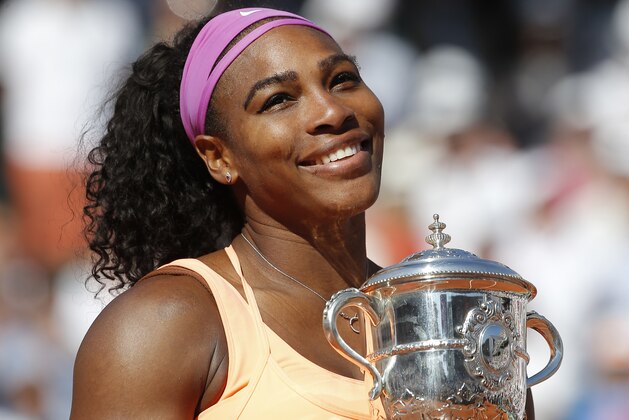 Serena Williams of the U.S. holds the trophy after winning the final of the French Open tennis tournament against Lucie Safarova of the Czech Republic in three sets, 6-3, 6-7, 6-2, at the Roland Garros stadium, in Paris, France, Saturday, June 6, 2015. (AP Photo/Michel Euler)