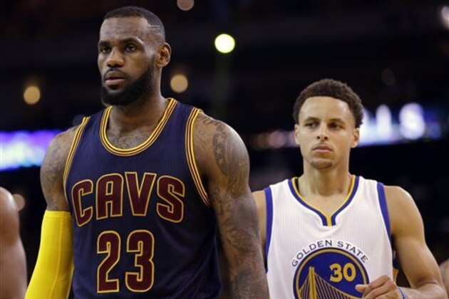 Cleveland Cavaliers forward LeBron James (23) walks in front of Golden State Warriors guard Stephen Curry (30) during the first half of Game 5 of basketball's NBA Finals in Oakland, Calif., Sunday, June 14, 2015. (AP Photo/Ben Margot)