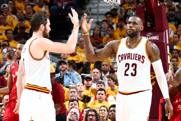 CLEVELAND, OH - MAY 19: Kevin Love #0 high fives teammate LeBron James #23 of the Cleveland Cavaliers during Game Two of the Eastern Conference Finals during the 2016 NBA Playoffs against the Toronto Raptors on May 19, 2016 at Quicken Loans Arena in Cleveland, Ohio. NOTE TO USER: User expressly acknowledges and agrees that, by downloading and or using this Photograph, user is consenting to the terms and conditions of the Getty Images License Agreement. Mandatory Copyright Notice: Copyright 2016 NBAE (Photo by Nathaniel Butler/NBAE via Getty Images)