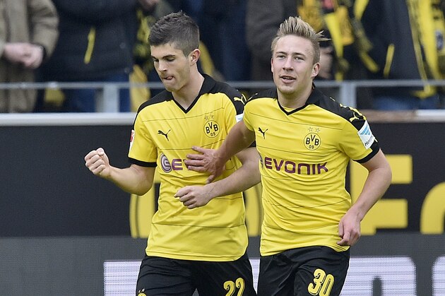 Dortmund's Christian Pulisic, left, celebrates with Felix Passlack, right, after scoring the opening goal during the German Bundesliga soccer match between Borussia Dortmund and Hamburger SV in Dortmund, Germany, Sunday, April 17, 2016. (AP Photo/Martin Meissner)