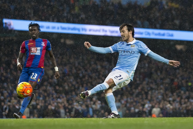 Manchester City's David Silva, right, scores past Crystal Palace's Pape N'Diaye Souare during the English Premier League soccer match between Manchester City and Crystal Palace at the Etihad Stadium, Manchester, England, Saturday Jan. 16, 2016. (AP Photo/Jon Super)