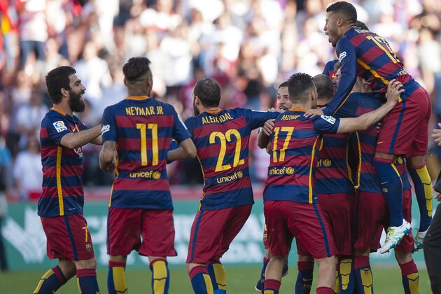 FC Barcelona’s Arda Turan from Turkey, Neymar da Silva from Brazil, Aleix Vidal, Munir el Haddadi, Sergio Busquets, Rafael Alcantara from Brazil, from left, celebrate after winning the Spanish League title, at the end of their Spanish La Liga last round soccer match against Granada at Los Carmenes stadium in Granada, Spain, Saturday, May 14, 2016. (AP Photo/Daniel Tejedo