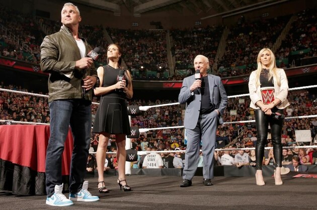 Charlotte signing a contract for her match against Natalya.