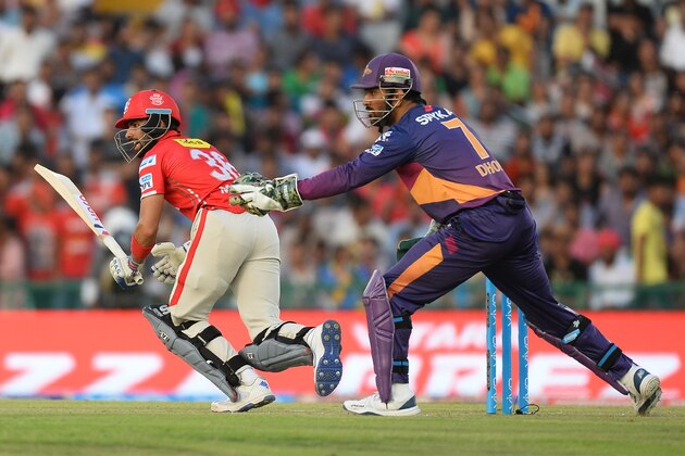 Kings XI Punjab batsman Manan Vohra plays a shot (L) as  Rising Pune Supergiants team captain MS Dhoni looks on  during the 2016 Indian Premier League (IPL) Twenty20 cricket match between Rising Pune Supergiants and Kings XI Punjab at The Punjab Cricket Association Stadium in Mohali on April 17, 2016  ------IMAGE RESTRICTED TO EDITORIAL USE - STRICTLY NO COMMERCIAL USE------ / AFP / SAJJAD HUSSAIN        (Photo credit should read SAJJAD HUSSAIN/AFP/Getty Images)