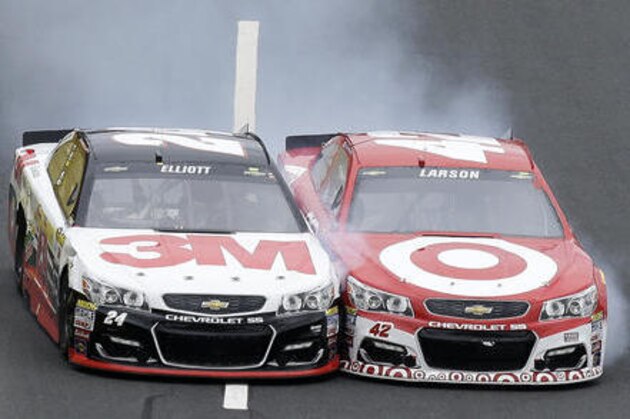 Chase Elliott (24) and Kyle Larson (42) race for the finish line during the NASCAR Sprint Cup Series Showdown auto race at the Charlotte Motor Speedway in Concord, N.C., Saturday, May 21, 2016. Larson won the segment. (AP Photo/Gerry Broome)