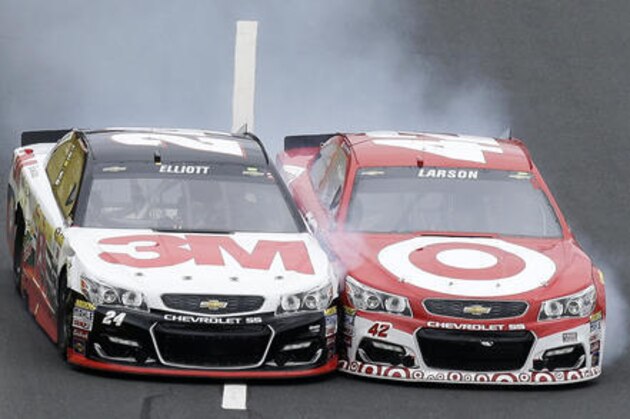 Chase Elliott (24) and Kyle Larson (42) race for the finish line during the NASCAR Sprint Cup Series Showdown auto race at the Charlotte Motor Speedway in Concord, N.C., Saturday, May 21, 2016. Larson won the segment. (AP Photo/Gerry Broome)