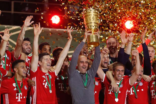 Bayern Munich's Spanish head coach Pep Guardiola and Bayern Munich's players celebrate with the trophy during the winners ceremony after winning the German Cup (DFB Pokal) final football match Bayern Munich vs Borussia Dortmund at the Olympic stadium in Berlin on May 21, 2016. / AFP / ODD ANDERSEN / RESTRICTIONS: ACCORDING TO DFB RULES IMAGE SEQUENCES TO SIMULATE VIDEO IS NOT ALLOWED DURING MATCH TIME. MOBILE (MMS) USE IS NOT ALLOWED DURING AND FOR FURTHER TWO HOURS AFTER THE MATCH. == RESTRICTED TO EDITORIAL USE == FOR MORE INFORMATION CONTACT DFB DIRECTLY AT +49 69 67880

 /         (Photo credit should read ODD ANDERSEN/AFP/Getty Images)