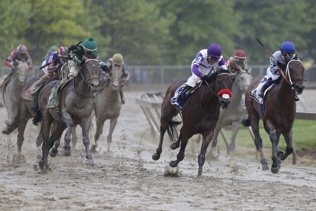 Exaggerator, left, with Kent Desormeaux aboard moves up on Nyquist (3) with Mario Gutierrez aboard during the 141st Preakness Stakes horse race at Pimlico Race Course, Saturday, May 21, 2016, in Baltimore. Exaggerator won the race. (AP Photo/Garry Jones)