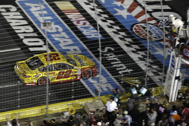 Joey Logano (22) approaches the checkered flag to win the NASCAR Sprint All-Star auto race at Charlotte Motor Speedway in Concord, N.C., Saturday, May 21, 2016. (AP Photo/Gerry Broome)