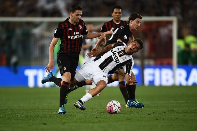 Juventus' forward from Argentina Paulo Dybala (C) fights for the ball with AC Milan's midfielder from Italy Riccardo Montolivo (R) during the Italian Tim Cup final football match AC Milan vs Juventus on May 21, 2016 at the Olympic Stadium in Rome.   AFP PHOTO / FILIPPO MONTEFORTE / AFP / FILIPPO MONTEFORTE        (Photo credit should read FILIPPO MONTEFORTE/AFP/Getty Images)