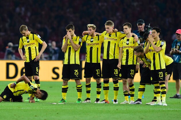 The team of Borussia Dortmund reacts during the penalty shootout of the German Cup (DFB Pokal) final football match Bayern Munich vs Borussia Dortmund at the Olympic stadium in Berlin on May 21, 2016. / AFP / TOBIAS SCHWARZ / RESTRICTIONS: ACCORDING TO DFB RULES IMAGE SEQUENCES TO SIMULATE VIDEO IS NOT ALLOWED DURING MATCH TIME. MOBILE (MMS) USE IS NOT ALLOWED DURING AND FOR FURTHER TWO HOURS AFTER THE MATCH. == RESTRICTED TO EDITORIAL USE == FOR MORE INFORMATION CONTACT DFB DIRECTLY AT +49 69 67880

 /         (Photo credit should read TOBIAS SCHWARZ/AFP/Getty Images)