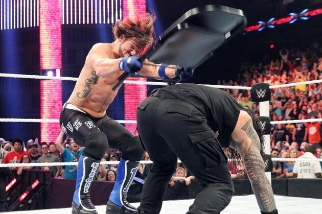 AJ Styles finally taking a steel chair to Roman Reigns.