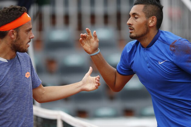 Australia's Nick Kyrgios, right, and Italy’s Marco Checchinato gesture during their first round of the French Open tennis tournament at Roland Garros stadium in Paris, France, Sunday, May 22, 2016. (AP Photo/Christophe Ena)