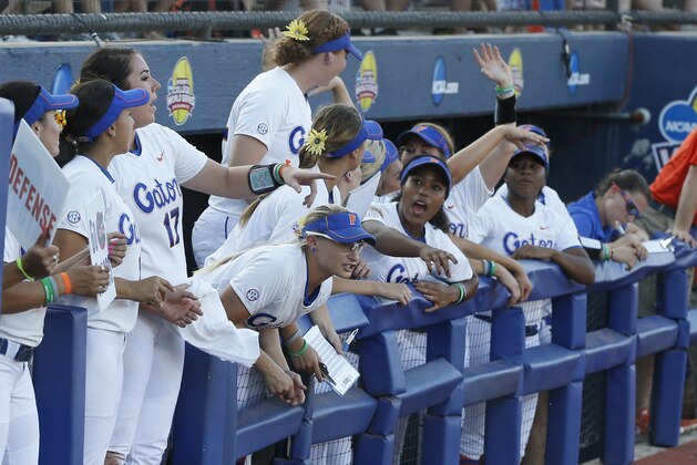 Florida players cheer in the dugout during the second inning against Michigan in the final game in the NCAA softball Women's College World Series, Wednesday, June 3, 2015, in Oklahoma City. (AP Photo/Sue Ogrocki)
