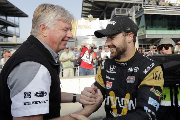 James Hinchcliffe, right, of Canada, celebrates with a crew member after he qualified on the opening day of qualifications for the Indianapolis 500 auto race at Indianapolis Motor Speedway in Indianapolis, Saturday, May 21, 2016. (AP Photo/Darron Cummings)