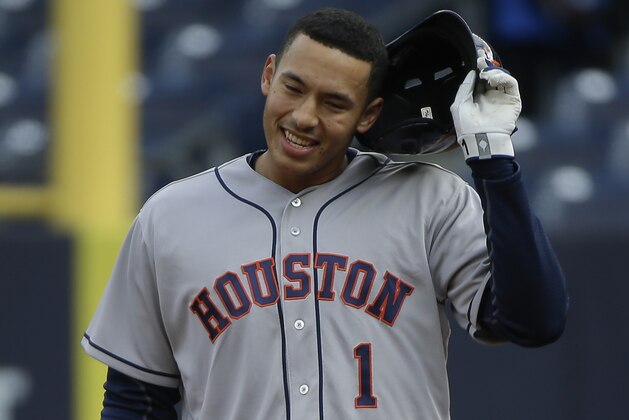 Houston Astros'Carlos Correa (1) pulls off his batting helmet after New York Yankees center fielder Jacoby Ellsbury made a leaping catch at the wall on a ball he hit during the first inning of a baseball game, Thursday, April 7, 2016, in New York. (AP Photo/Julie Jacobson)