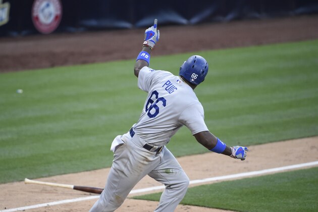 SAN DIEGO, CALIFORNIA - MAY 22:  Yasiel Puig #66 of the Los Angeles Dodgers  points back to the dugout after hitting a two RBI single during the 17th inning of a baseball game against the San Diego Padres at PETCO Park on May 22, 2016 in San Diego, California.  (Photo by Denis Poroy/Getty Images)