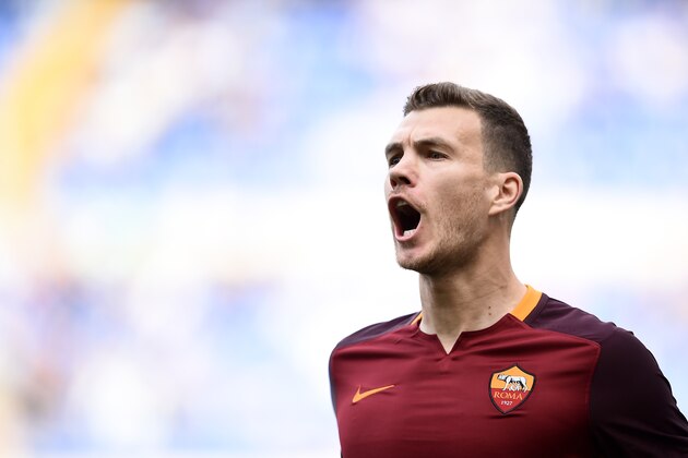 Roma's forward from Bosnia Edin Dzeko celebrates after scoring during the Italian Serie A football match Lazio vs AS Roma at the Olympic stadium in Rome on April 3, 2016     / AFP / FILIPPO MONTEFORTE        (Photo credit should read FILIPPO MONTEFORTE/AFP/Getty Images)