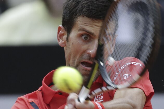 Novak Djokovic returns a backhand to Andy Murray, during their final match at the Italian Open tennis tournament, in Rome, Sunday, May 15, 2016. (AP Photo/Alessandra Tarantino)