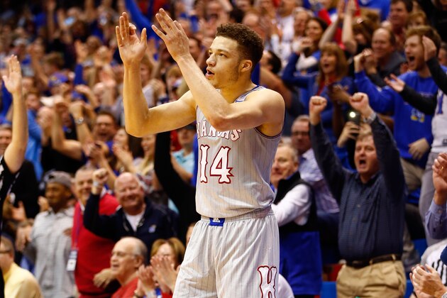 LAWRENCE, KS - FEBRUARY 15:  Brannen Greene #14 of the Kansas Jayhawks reacts after making a three-pointer at the buzzer during the first half of the game against the Oklahoma State Cowboys at Allen Fieldhouse on February 15, 2016 in Lawrence, Kansas.  (Photo by Jamie Squire/Getty Images)