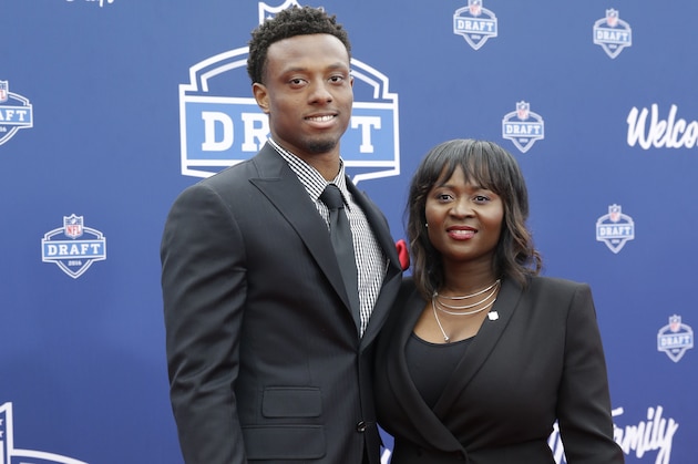 Ohio State’s Eli Apple, left, poses for photos upon arriving for the first round of the 2016 NFL football draft at the Auditorium Theater of Roosevelt University, Thursday, April 28, 2016, in Chicago. (AP Photo/Nam Y. Huh)