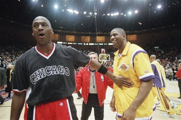 The Chicago Bulls’ Michael Jordan, left, exchanges greetings with the Los Angeles Lakers’ Earvin “Magic” Johnson, at halftime at the Great Western Forum in Inglewood, Calif., on Friday, Feb. 2, 1996. (AP Photo/Kevork Djansezian)