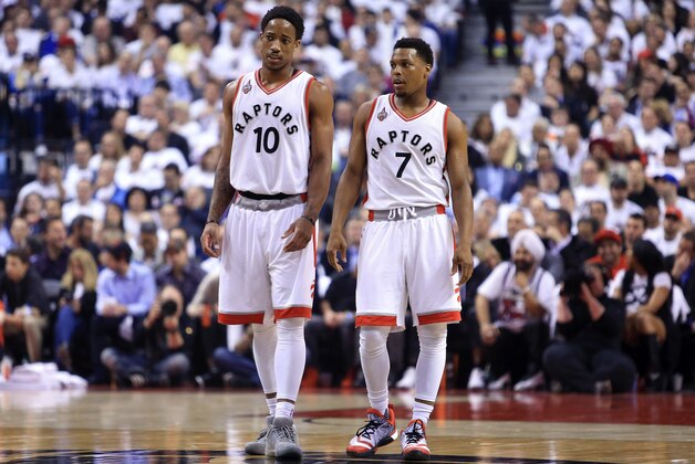 TORONTO, ON - MAY 11:  DeMar DeRozan #10 and Kyle Lowry #7 of the Toronto Raptors talk in the first half of Game Five of the Eastern Conference Semifinals against the Miami Heat during the 2016 NBA Playoffs at the Air Canada Centre on May 11, 2016 in Toronto, Ontario, Canada.  NOTE TO USER: User expressly acknowledges and agrees that, by downloading and or using this photograph, User is consenting to the terms and conditions of the Getty Images License Agreement.  (Photo by Vaughn Ridley/Getty Images)