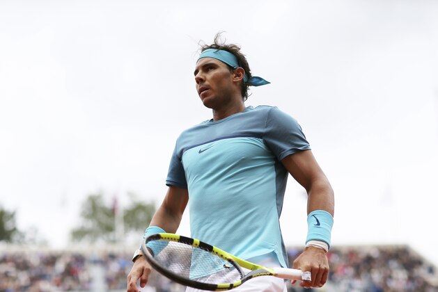 Spain's Rafael Nadal walks towards a ball boy as he plays his first round match of the French Open tennis tournament against Australia’s Sam Groth at the Roland Garros stadium in Paris, France, Tuesday, May 24, 2016. (AP Photo/David Vincent)