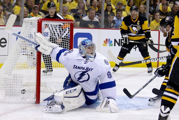 The puck gets behind Tampa Bay Lightning goalie Andrei Vasilevskiy (88) on a shot by Pittsburgh Penguins' Patric Hornqvist, right, for a goal, as Sidney Crosby, center, celebrates during the second period of Game 5 of the NHL hockey Stanley Cup Eastern Conference finals, Sunday, May 22, 2016, in Pittsburgh. (AP Photo/Gene J. Puskar)