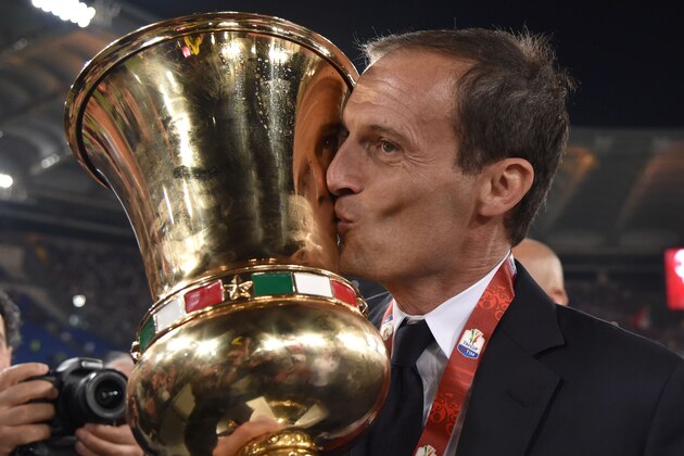 Juventus' coach from Italy Massimiliano Allegri kisses the trophy after winning the Italian Tim Cup final football match AC Milan vs Juventus on May 21, 2016 at the Olympic Stadium in Rome.  Juventus won 0-1 in the extra time.     AFP PHOTO / TIZIANA FABI / AFP / TIZIANA FABI        (Photo credit should read TIZIANA FABI/AFP/Getty Images)