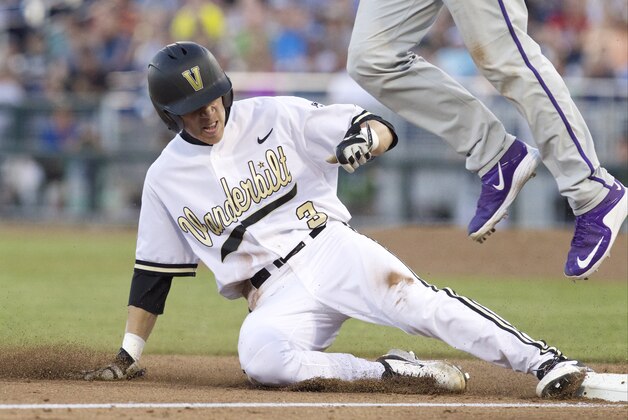 Jun 19, 2015; Omaha, NE, USA; Vanderbilt Commodores runner Jeren Kendall (3) slides safely into third against TCU Horned Frogs third baseman Derek Odell (5) (26) misses the throw in the sixth inning in the 2015 College World Series at TD Ameritrade Park. Vanderbilt won 7-1. Mandatory Credit: Bruce Thorson-USA TODAY Sports
