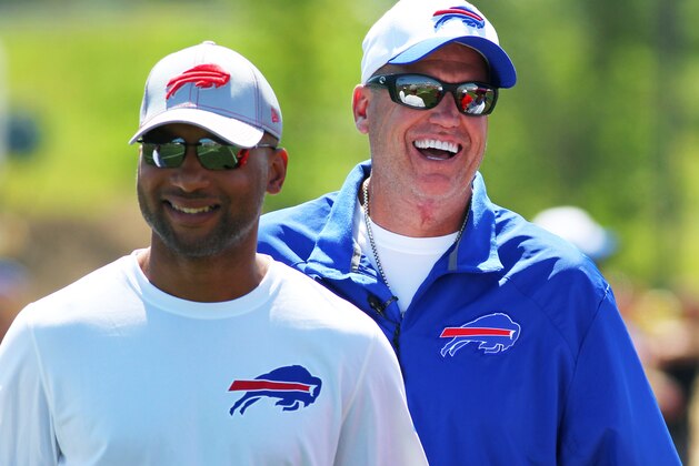 Buffalo Bills general manager Doug Whaley, left, and head coach Rex Ryan share a laugh during their team's NFL football training camp in Pittsford, N.Y., Friday, July 31, 2015. (AP Photo/Bill Wippert)