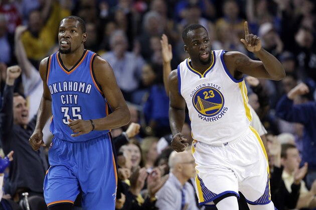 Golden State Warriors' Draymond Green (23) celebrates after scoring next to Oklahoma City Thunder's Kevin Durant (35) during the first half of an NBA basketball game Thursday, March 3, 2016, in Oakland, Calif. (AP Photo/Marcio Jose Sanchez)