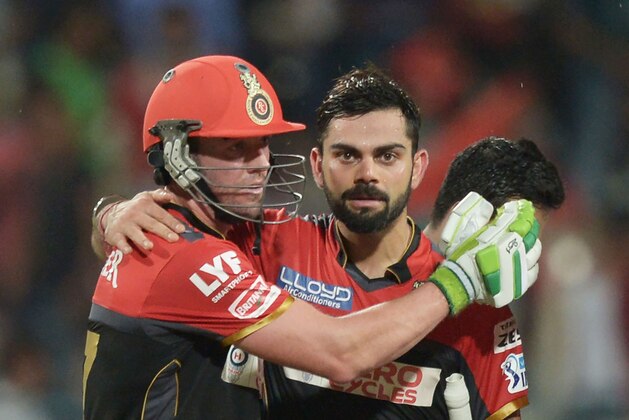 Royal Challengers Bangalore captain Virat Kohli (R) and AB de Villiers celebrate after winning the match after the 2016 Indian Premier League (IPL) Twenty20 cricket match between Kolkata Knight Riders and Royal Challengers Bangalore at the Eden Gardens Cricket Stadium in Kolkata on May 16, 2016.  ----IMAGE RESTRICTED TO EDITORIAL USE - STRICTLY NO COMMERCIAL USE----- / GETTYOUT' / AFP / Dibyangshu SARKAR        (Photo credit should read DIBYANGSHU SARKAR/AFP/Getty Images)