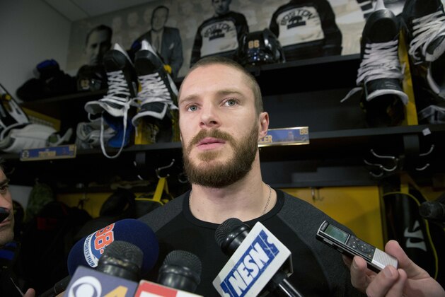 Boston Bruins' Kevan Miller speaks with reporters at TD Garden in Boston, Monday, April 11, 2016 following the team's final game of the NHL hockey season. (AP Photo/Michael Dwyer)