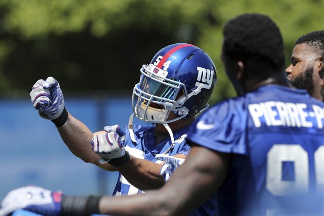 New York Giants defensive end Jason Pierre-Paul (90) looks on as defensive end Olivier Vernon (54) works on a drill during NFL football practice Monday, May 23, 2016 in East Rutherford, N.J. (AP Photo/Mel Evans)