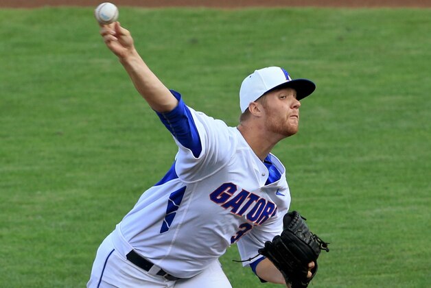 FILE - In this June 13, 2015 file photo, Florida starting pitcher Logan Shore throws during an NCAA College World Series baseball game against Miami in Omaha, Neb. Shore and fellow pitchers A.J. Puk and Alex Faedo are an imposing weekend rotation that combined for a 26-11 record last season. (AP Photo/Nati Harnik, file)