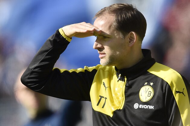 Dortmund head coach Thomas Tuchel watches the pitch against the sun during the German Bundesliga soccer match between Borussia Dortmund and Hamburger SV in Dortmund, Germany, Sunday, April 17, 2016. (AP Photo/Martin Meissner)