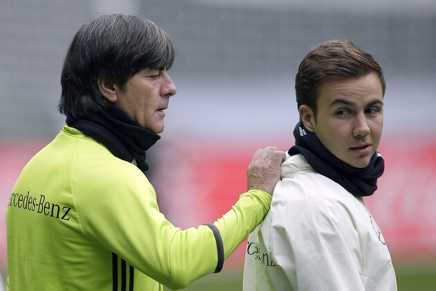 Coach Joachim Loew, left, talks to player Mario Goetze, right, during a training session of the German national soccer team in Berlin, Germany, Friday, March 25, 2016. Germany will face the team of England on Saturday, March 26, 2016 for a friendly soccer match in the German capital Berlin. (AP Photo/Michael Sohn)