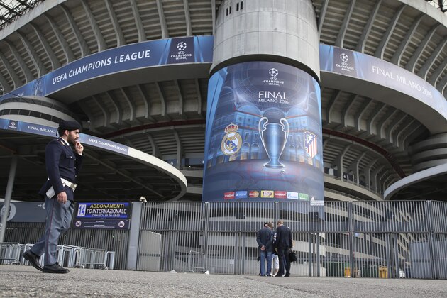 A police officer patrols outside the San Siro stadium, in Milan, Italy, Wednesday, May 25, 2016. The Champions League soccer final between Real Madrid and Atletico Madrid will be held at the San Siro stadium on Saturday, May 28, 2016. (AP Photo/Luca Bruno)