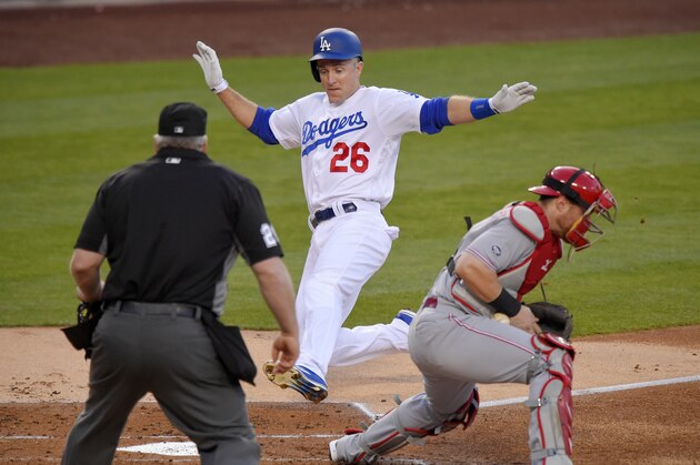 Los Angeles Dodgers' Chase Utley, center, scores on a single by Justin Turner as Cincinnati Reds catcher Tucker Barnhart, right, takes a late throw while home plate umpire Bill Miller watches during the first inning of a baseball game, Tuesday, May 24, 2016, in Los Angeles. (AP Photo/Mark J. Terrill)