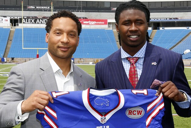 FILE- In this May 9, 2014, file photo, Buffalo Bills first-round draft pick Sammy Watkins, right, poses for photos with general manager Doug Whaley at Ralph Wilson Stadium in Orchard Park, N.Y.  Whaley's swing-for-the-fences philosophy is evident in the new-look offense the Bills will unveil Sunday, when they open training camp in suburban Rochester. There's rookie receiver Sammy Watkins, who was drafted fourth overall after Whaley traded Buffalo's 2015 first-round pick to Cleveland.  (AP Photo/Bill Wippert, File)