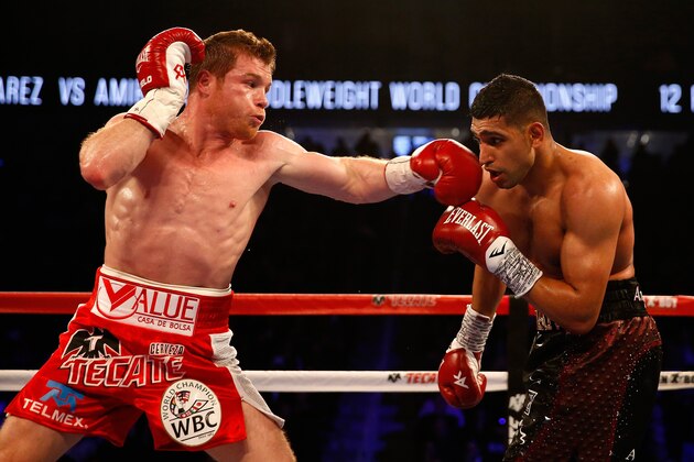 LAS VEGAS, NEVADA - MAY 07:  Canelo Alvarez (L) throws a left at Amir Khan during the WBC middleweight title fight at T-Mobile Arena on May 7, 2016 in Las Vegas, Nevada.  (Photo by Christian Petersen/Getty Images)