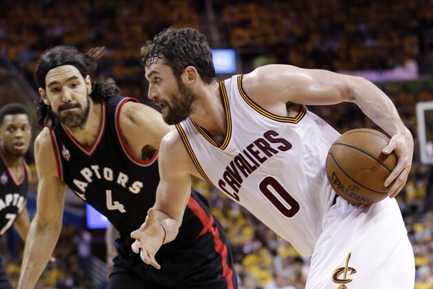 Cleveland Cavaliers' Kevin Love (0) drives on Toronto Raptors' Luis Scola (4), from Argentina, during the second half of Game 5 of the NBA basketball Eastern Conference finals Wednesday, May 25, 2016, in Cleveland. (AP Photo/Tony Dejak)